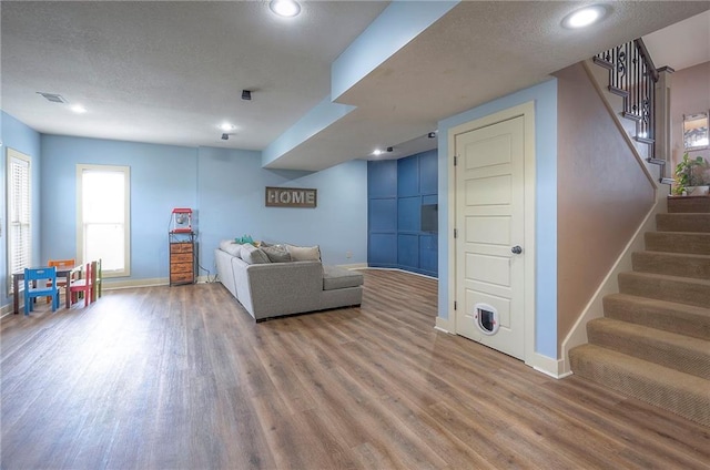 10111 N Tullis Dr, Kansas City, MO 64157 - living area with baseboards, wood finished floors, stairs, recessed lighting, and a textured ceiling