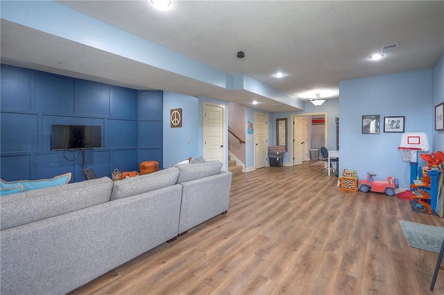 10111 N Tullis Dr, Kansas City, MO 64157 - living room with light wood-style floors, stairway, and recessed lighting