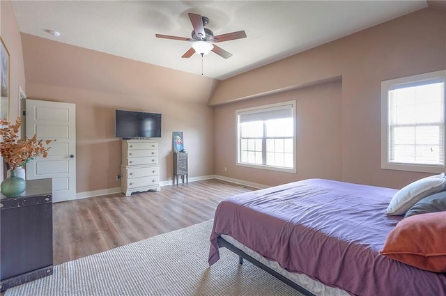 10111 N Tullis Dr, Kansas City, MO 64157 - bedroom featuring wood finished floors, lofted ceiling, baseboards, and a ceiling fan