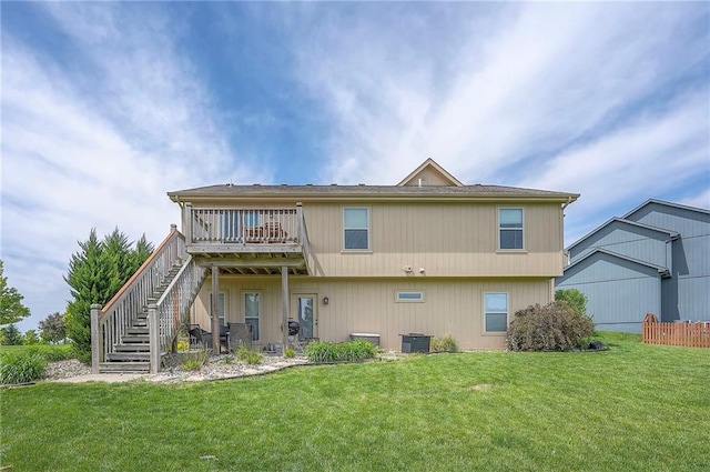 10111 N Tullis Dr, Kansas City, MO 64157 - back of house with stairs, central AC, a lawn, and a wooden deck