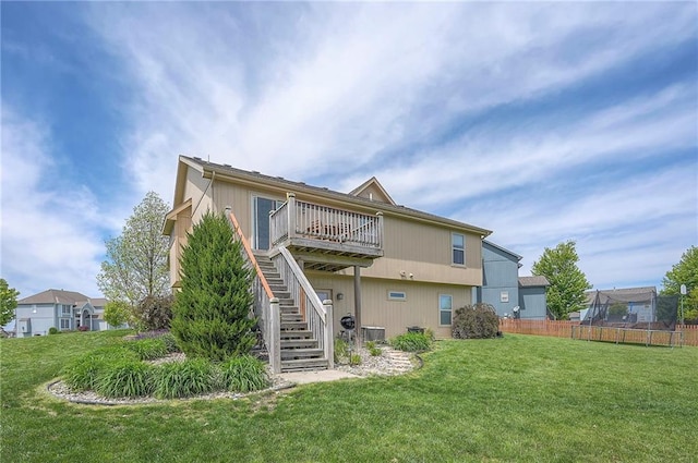 10111 N Tullis Dr, Kansas City, MO 64157 - back of property with stairs, a wooden deck, and central AC unit