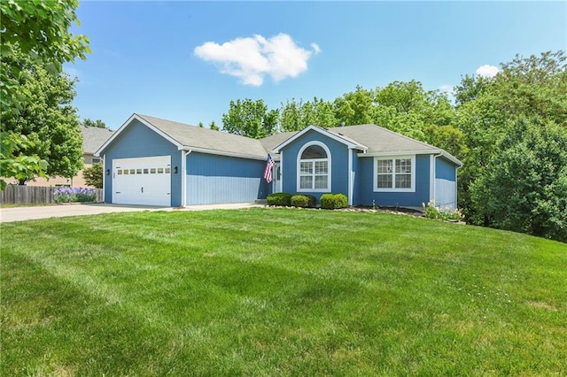 single story home with driveway and an attached garage