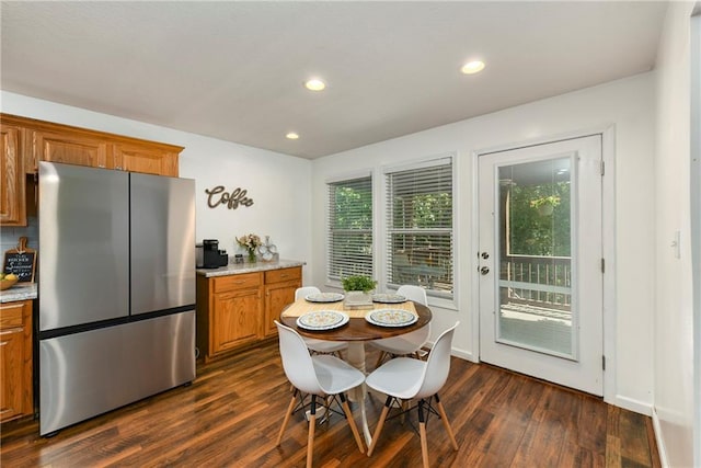dining space with dark wood finished floors, healthy amount of natural light, and recessed lighting