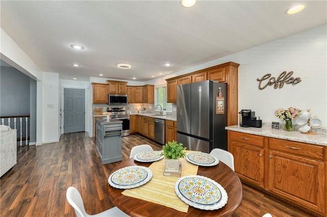 dining room featuring dark wood-type flooring, recessed lighting, and baseboards
