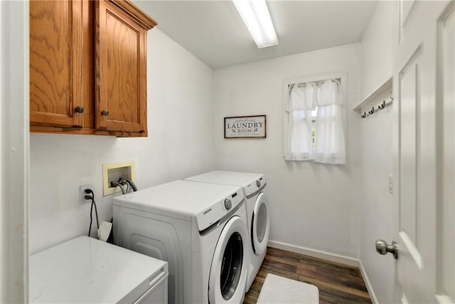 washroom with cabinet space, washing machine and dryer, dark wood-style floors, and baseboards