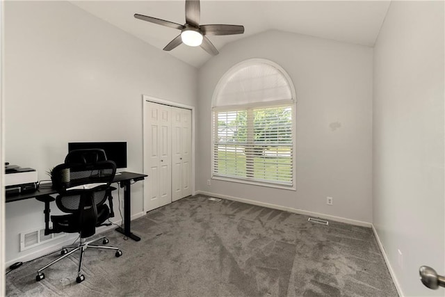 carpeted home office featuring a ceiling fan, vaulted ceiling, and baseboards