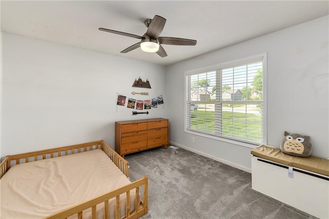 carpeted bedroom featuring baseboards and a ceiling fan