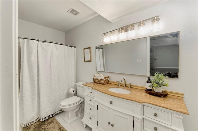 bathroom with toilet, vanity, tile patterned floors, and a shower with curtain