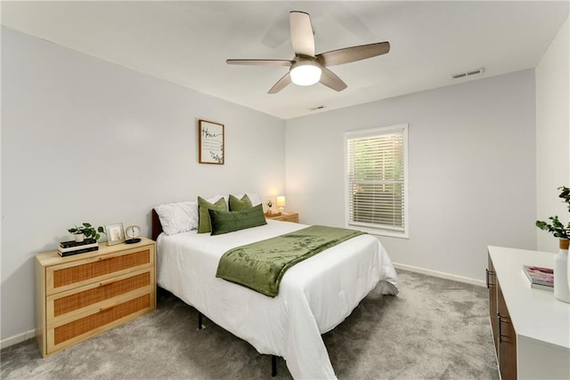 bedroom featuring light carpet, baseboards, and a ceiling fan