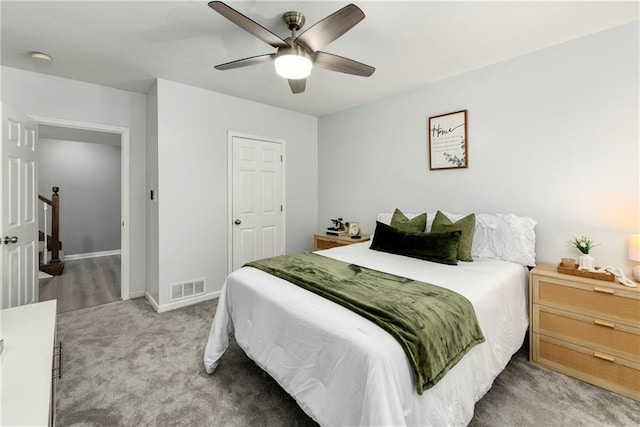 bedroom featuring light colored carpet, baseboards, and ceiling fan
