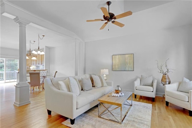 living room featuring ceiling fan, ornate columns, light wood-type flooring, and baseboards
