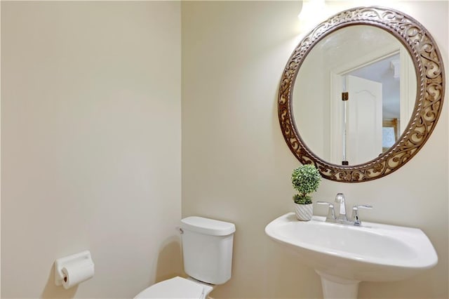 bathroom with toilet and a sink