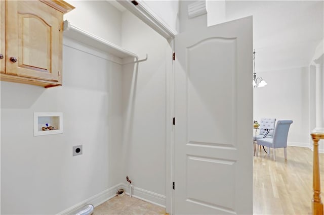 laundry room with cabinet space, hookup for an electric dryer, hookup for a washing machine, and baseboards