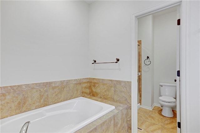 bathroom featuring toilet and a garden tub