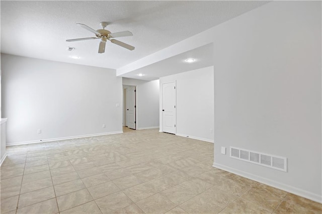 empty room featuring ceiling fan, baseboards, recessed lighting, a textured ceiling, and light tile patterned floors
