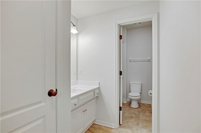 bathroom featuring toilet and vanity