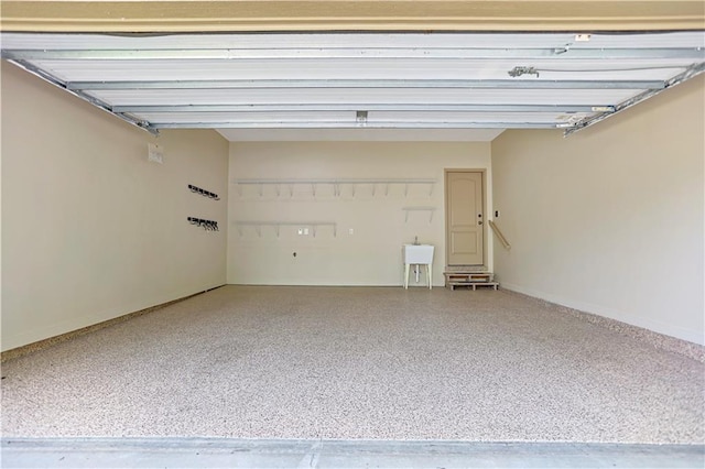 garage with baseboards and a sink