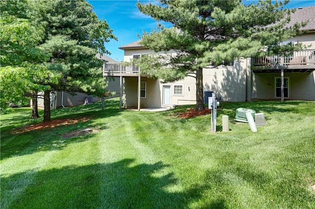 view of grassy yard featuring a deck