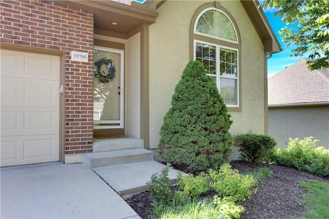 doorway to property with stucco siding and brick siding