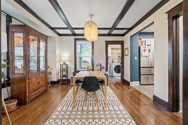 110 N Brighton Ave, Kansas City, MO 64123 - dining area featuring washer / clothes dryer, baseboards, a chandelier, hardwood / wood-style flooring, and coffered ceiling