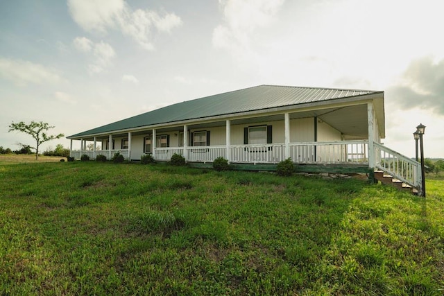 23249 NW Mitchell Rd, Garnett, KS 66032 - farmhouse-style home featuring a porch, metal roof, and a front yard