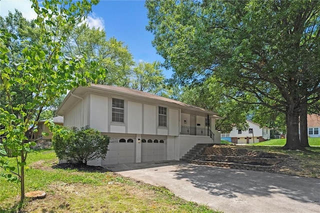 13300 Palmer Ave, Grandview, MO 64030 - view of front of house with an attached garage, stairs, and driveway