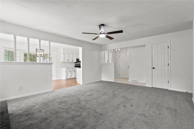 13300 Palmer Ave, Grandview, MO 64030 - spare room with light carpet, ceiling fan, a textured ceiling, and a chandelier
