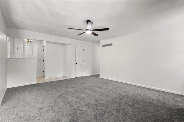 13300 Palmer Ave, Grandview, MO 64030 - carpeted spare room with ceiling fan and a textured ceiling