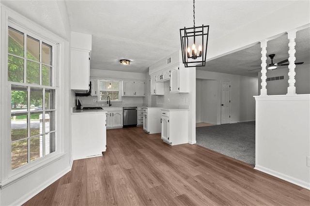 13300 Palmer Ave, Grandview, MO 64030 - kitchen featuring stainless steel dishwasher, a ceiling fan, and healthy amount of natural light