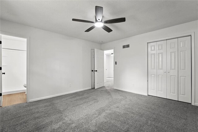 13300 Palmer Ave, Grandview, MO 64030 - unfurnished bedroom featuring carpet flooring, connected bathroom, a textured ceiling, ceiling fan, and a closet