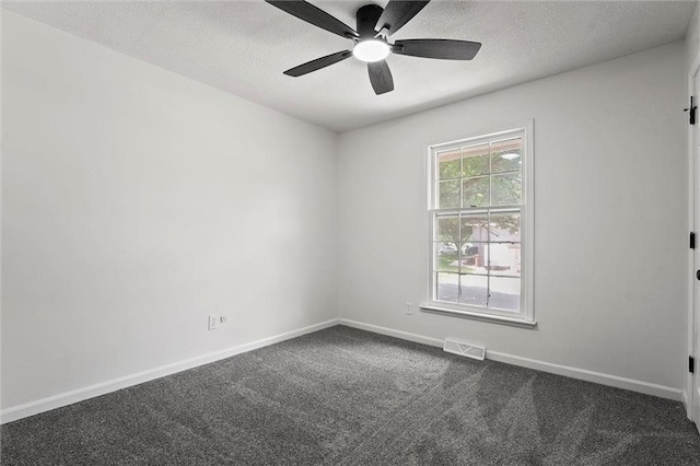 13300 Palmer Ave, Grandview, MO 64030 - empty room featuring dark colored carpet, ceiling fan, and a textured ceiling