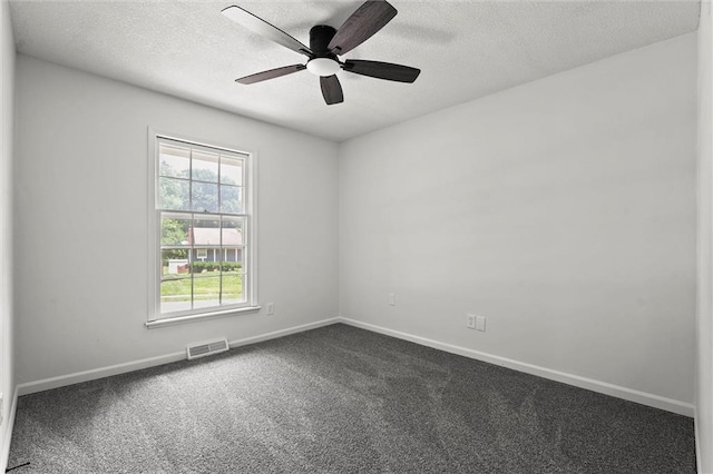 13300 Palmer Ave, Grandview, MO 64030 - spare room with a textured ceiling, dark colored carpet, and a ceiling fan