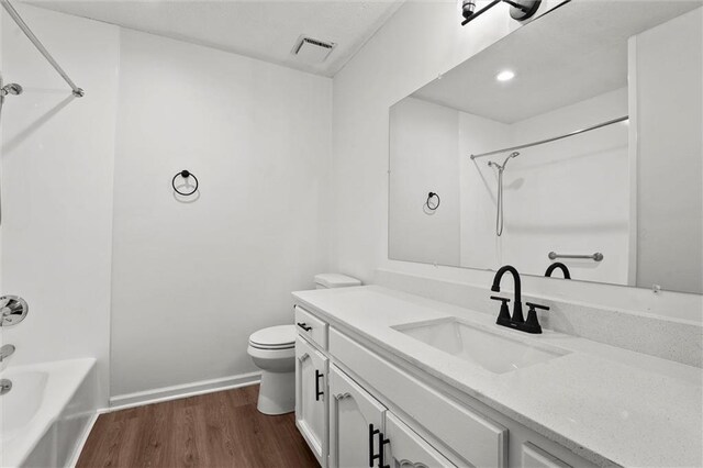 13300 Palmer Ave, Grandview, MO 64030 - bathroom featuring wood finished floors, vanity, and tub / shower combination