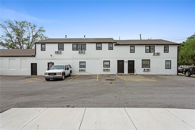 view of building exterior featuring uncovered parking