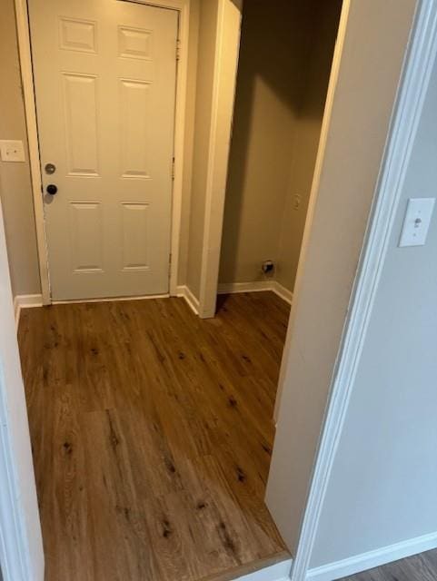hall with wood finished floors and baseboards