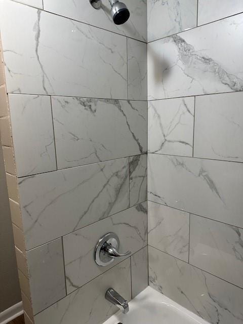 bathroom view of bathing tub / shower combination