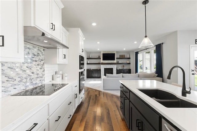 16780 W 170th Ct, Olathe, KS 66062 - kitchen featuring a sink, under cabinet range hood, black electric cooktop, stainless steel oven, and dark wood-style floors