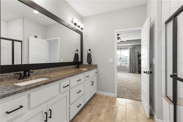 16780 W 170th Ct, Olathe, KS 66062 - full bathroom featuring double vanity, ceiling fan, baseboards, and a tile shower