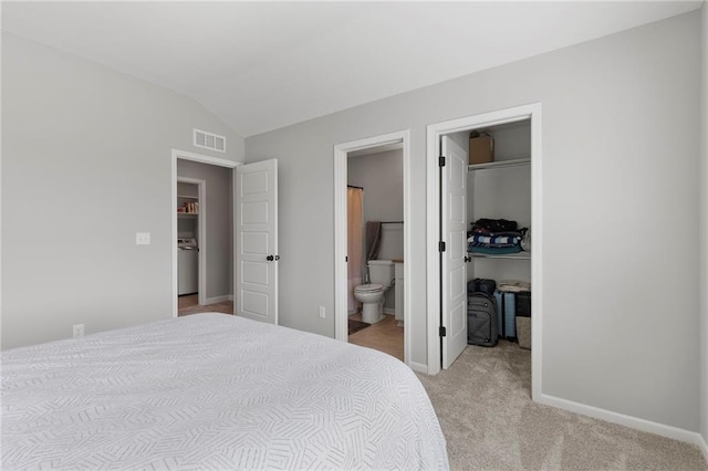 16780 W 170th Ct, Olathe, KS 66062 - bedroom with light carpet, lofted ceiling, a walk in closet, connected bathroom, and baseboards