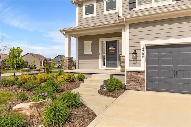 16780 W 170th Ct, Olathe, KS 66062 - entrance to property featuring a porch, stone siding, and concrete driveway