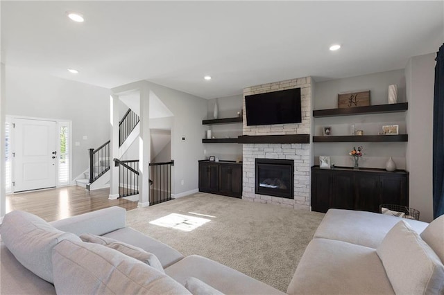 16780 W 170th Ct, Olathe, KS 66062 - living area featuring stairs, recessed lighting, light colored carpet, a stone fireplace, and baseboards