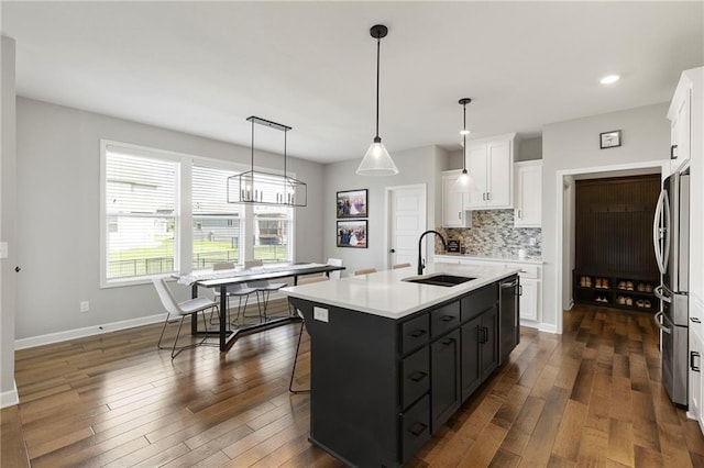 16780 W 170th Ct, Olathe, KS 66062 - kitchen featuring a sink, white cabinets, stainless steel appliances, backsplash, and a center island with sink