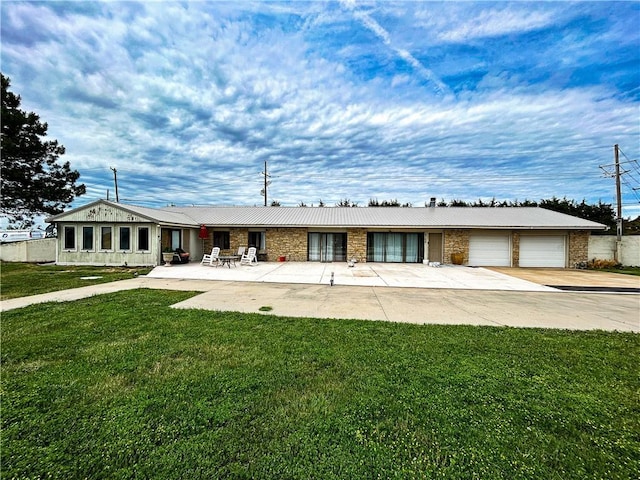 12100 Hedge Lane Ter, Olathe, KS 66061 - ranch-style house with a front yard, driveway, and a garage