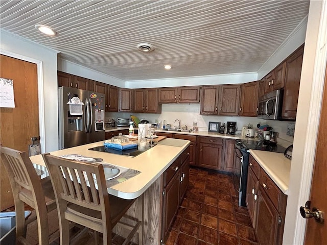 12100 Hedge Lane Ter, Olathe, KS 66061 - kitchen with stainless steel appliances, a sink, light countertops, a kitchen island, and recessed lighting