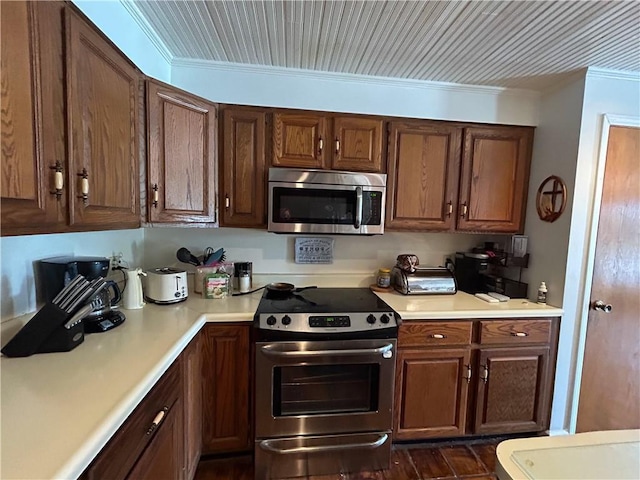 12100 Hedge Lane Ter, Olathe, KS 66061 - kitchen with stainless steel appliances, ornamental molding, and light countertops