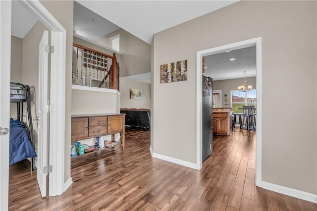 21923 W 116th Pl, Olathe, KS 66061 - hall with baseboards, wood finished floors, a chandelier, and stairway