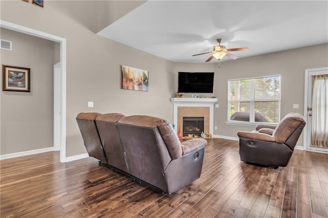 21923 W 116th Pl, Olathe, KS 66061 - living area featuring a ceiling fan, a glass covered fireplace, dark wood-style floors, and baseboards