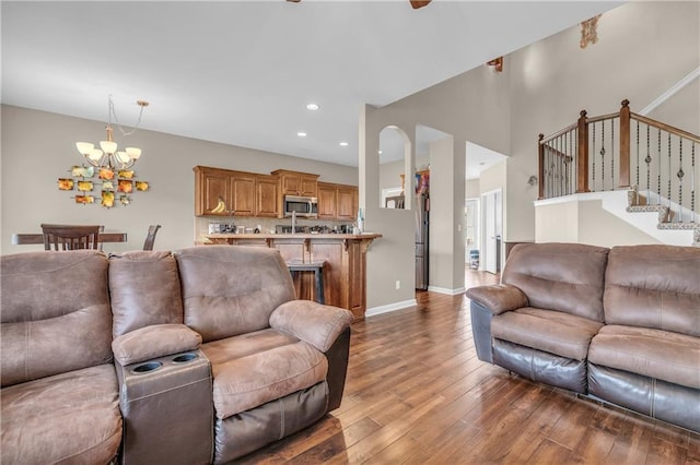 21923 W 116th Pl, Olathe, KS 66061 - living room with a chandelier, wood finished floors, stairway, recessed lighting, and baseboards