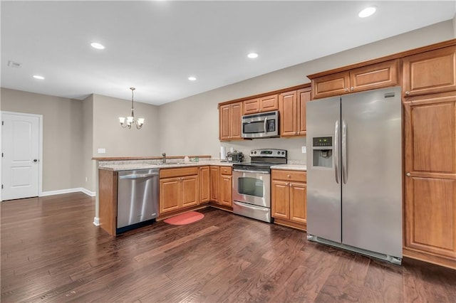 21923 W 116th Pl, Olathe, KS 66061 - kitchen with stainless steel appliances, a chandelier, light countertops, a peninsula, and dark wood-type flooring