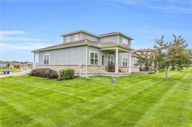 21923 W 116th Pl, Olathe, KS 66061 - view of side of property with stone siding, stucco siding, and a lawn
